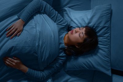 Woman sleeping in a bed